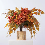 Golden Hour Fall Hydrangea, Birch Leaf, Orange Crater Berry & Yellow Astilbe Water Illusion Arrangement in Rattan Vase