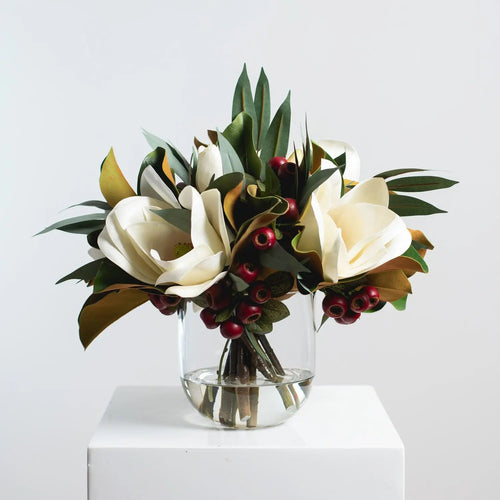 Holiday White Magnolia, Red Crabapple & Needle Leaf Eucalyptus Christmas Floral Arrangement Centerpiece in Glass Vase