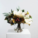 Holiday White Magnolia, Red Crabapple & Needle Leaf Eucalyptus Christmas Floral Arrangement Centerpiece in Glass Vase